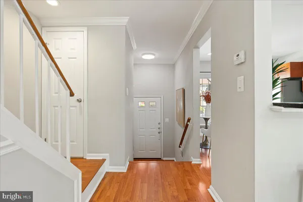 a view of a hallway with wooden floor and staircase