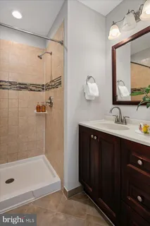 a bathroom with a bathtub sink and mirror