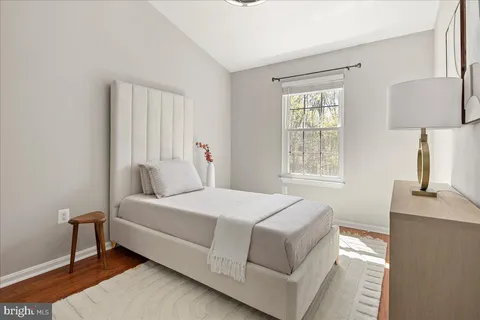 a bedroom with a bed and a potted plant