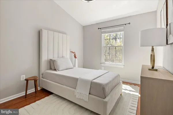 a bedroom with a bed and a potted plant