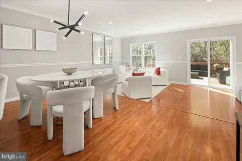 a dining room with furniture and wooden floor