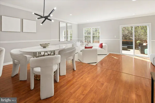 a dining room with furniture and wooden floor