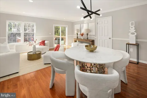 a living room with furniture a flat screen tv and a large window