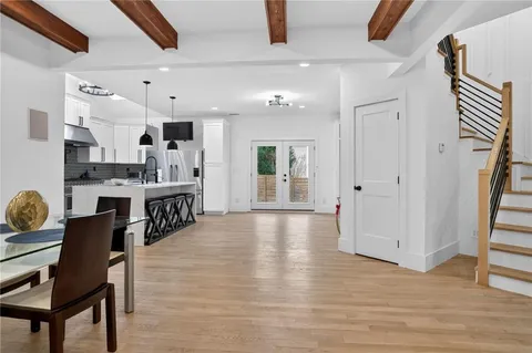 a large kitchen with a table and chairs