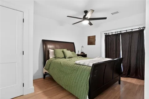 a bedroom with a bed and a mirror