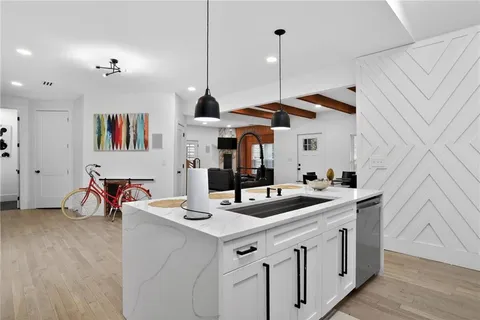 a kitchen with stainless steel appliances kitchen island granite countertop a sink and cabinets