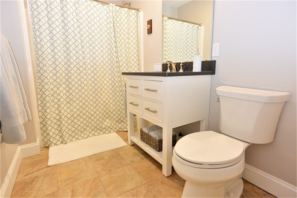 424 Langen Road Lancaster, MA 01523 - Photo 14 of 25 a bathroom with a sink a toilet and shower