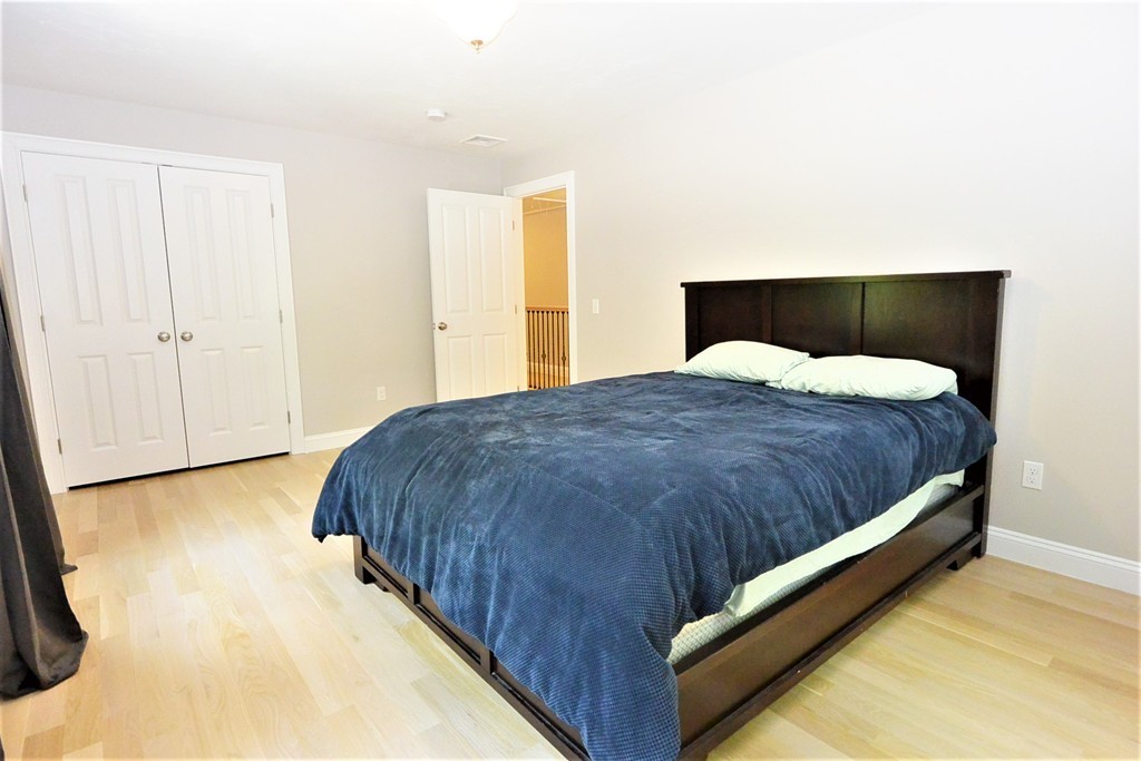 424 Langen Road Lancaster, MA 01523 - Photo 16 of 25 a bed sitting in a bedroom next to a window