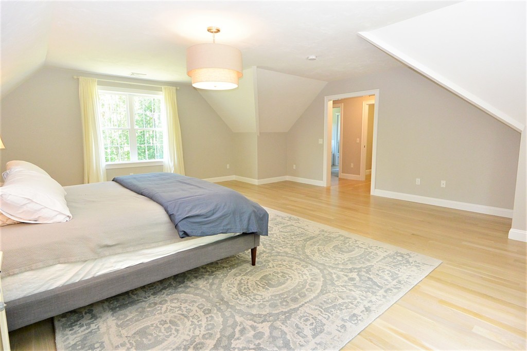 424 Langen Road Lancaster, MA 01523 - Photo 19 of 25 a spacious bedroom with a bed a dresser and a large window