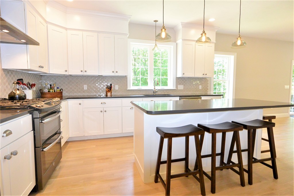 424 Langen Road Lancaster, MA 01523 - Photo 3 of 25 a kitchen with a table chairs sink and cabinets