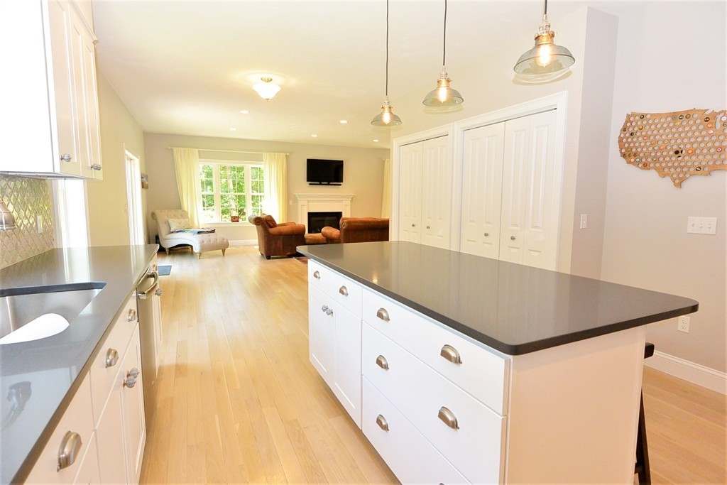 424 Langen Road Lancaster, MA 01523 - Photo 5 of 25 a kitchen with stainless steel appliances granite countertop a sink and a living room view