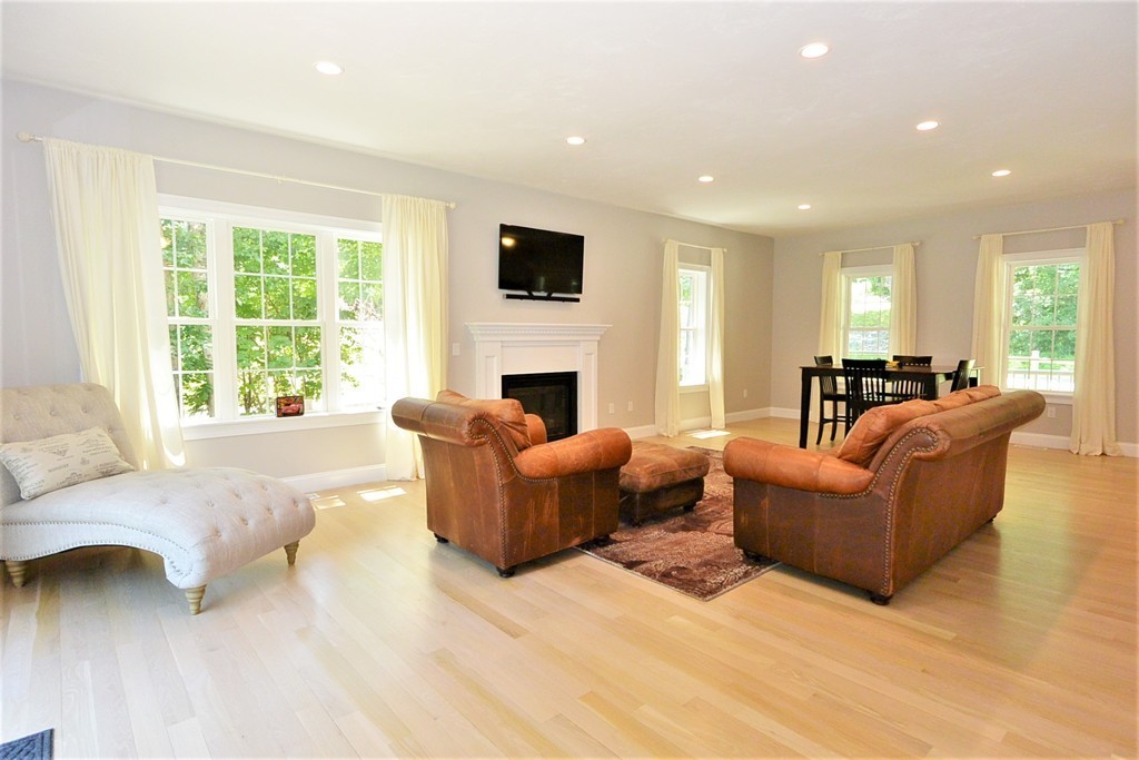 424 Langen Road Lancaster, MA 01523 - Photo 8 of 25 a living room with furniture and a fireplace