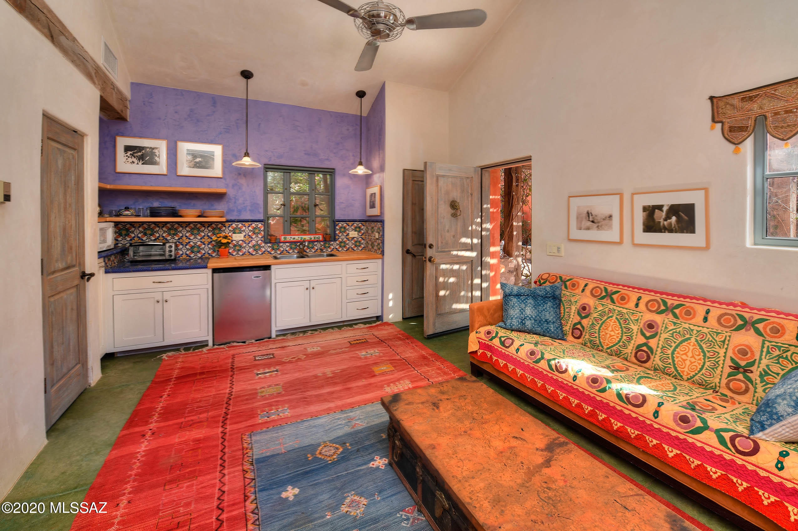 360 Harshaw Creek Road Patagonia, AZ 85624 - Photo 33 of 50 a bed room with a bed window and wall painting