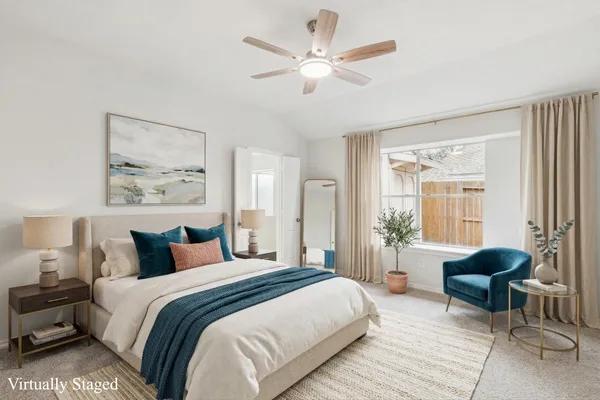 an empty room with closet and a ceiling fan