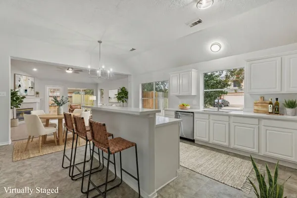 a kitchen with kitchen island white cabinets and white appliances