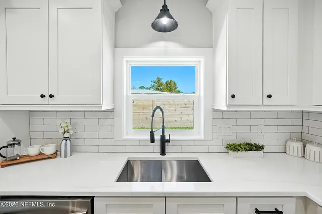 a kitchen with sink and cabinets