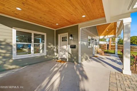 a view of a porch with a table and chairs