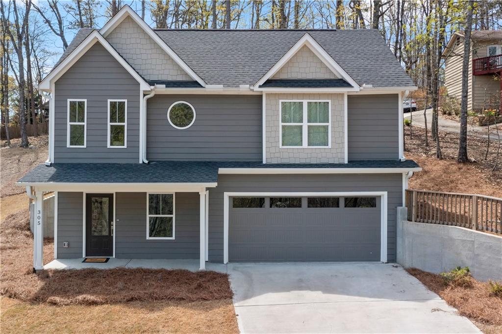 a front view of a house with a garage and yard