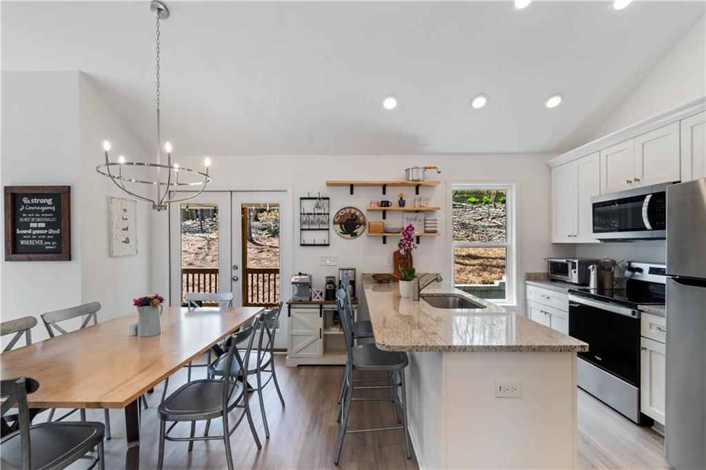 305 Ridgewood Drive Waleska, GA 30183 - Photo 14 of 56 a kitchen with stainless steel appliances kitchen island granite countertop a sink and cabinets