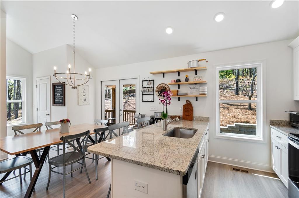 305 Ridgewood Drive Waleska, GA 30183 - Photo 15 of 56 a view of a dining room and livingroom with furniture wooden floor a chandelier
