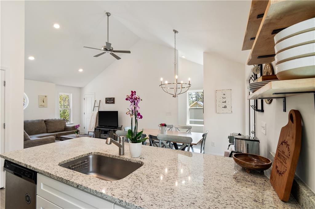 305 Ridgewood Drive Waleska, GA 30183 - Photo 16 of 56 a kitchen with kitchen island granite countertop a sink a counter and living room view