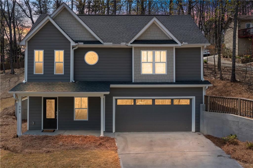 305 Ridgewood Drive Waleska, GA 30183 - Photo 2 of 56 a front view of a house with yard and garage