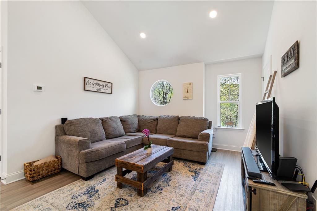 305 Ridgewood Drive Waleska, GA 30183 - Photo 22 of 56 a living room with furniture a flat screen tv and a window