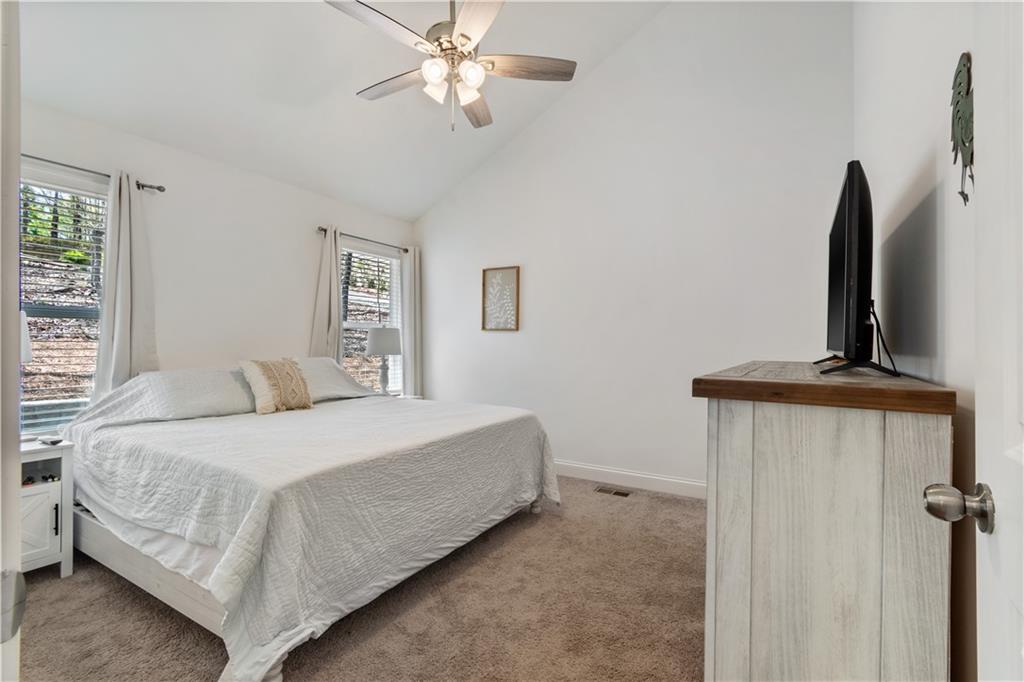 305 Ridgewood Drive Waleska, GA 30183 - Photo 26 of 56 a bedroom with a bed and a flat screen tv