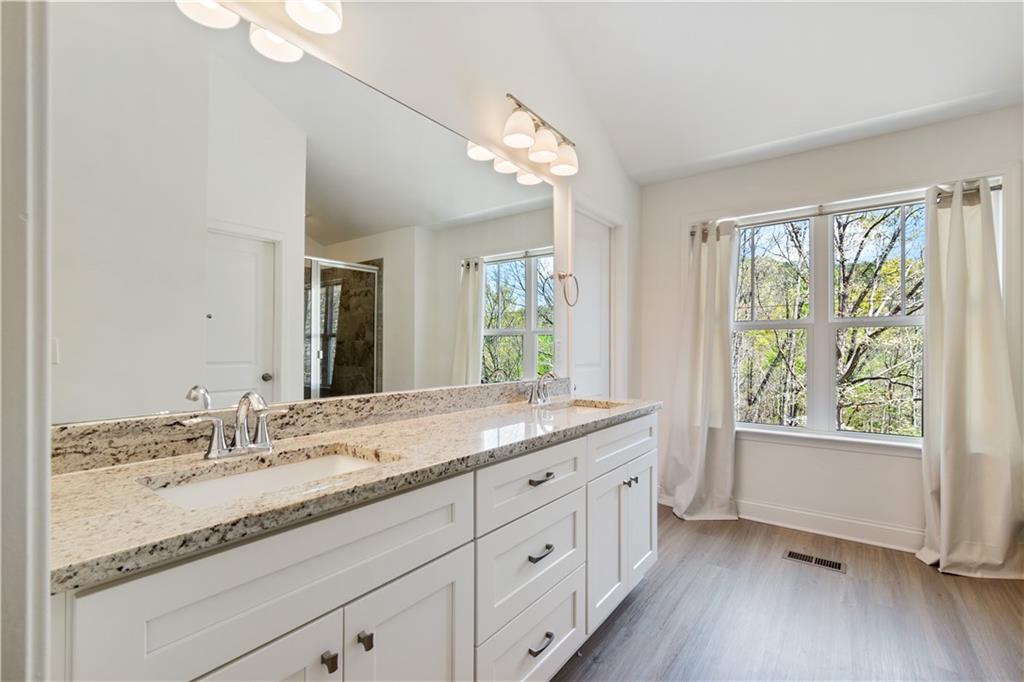305 Ridgewood Drive Waleska, GA 30183 - Photo 29 of 56 a bathroom with a granite countertop sink mirror and a shower