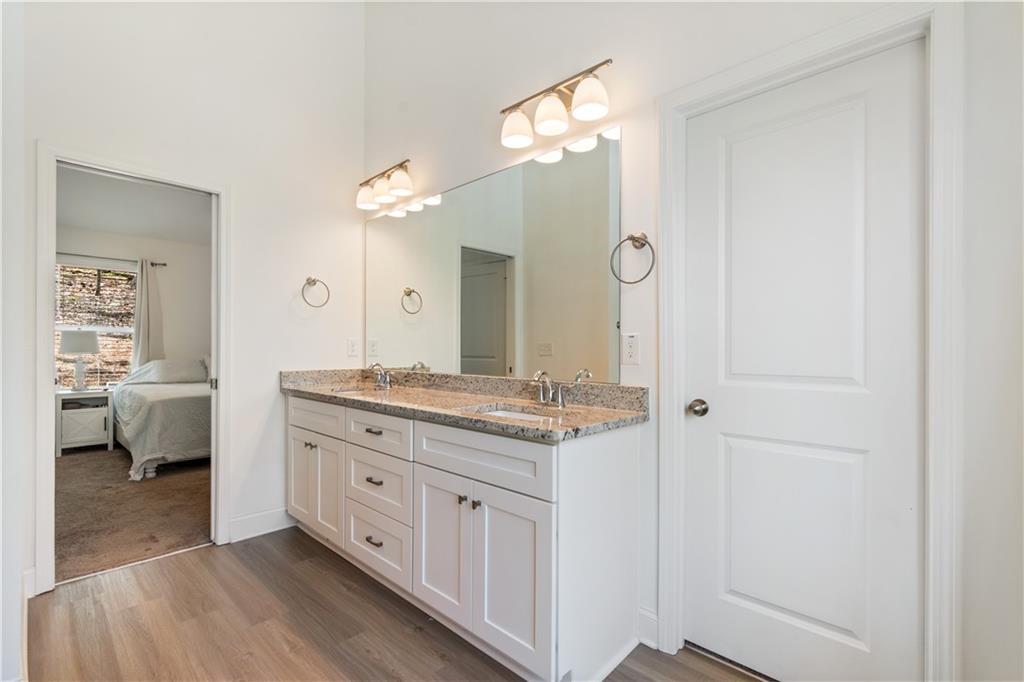 305 Ridgewood Drive Waleska, GA 30183 - Photo 30 of 56 a spacious bathroom with a granite countertop sink a mirror and a shower