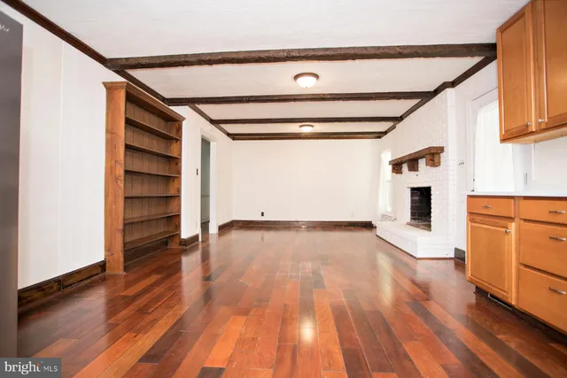 wooden floor in an empty room with a fireplace