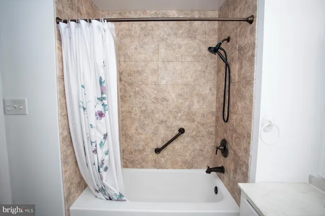 a bathroom with a shower and a tub