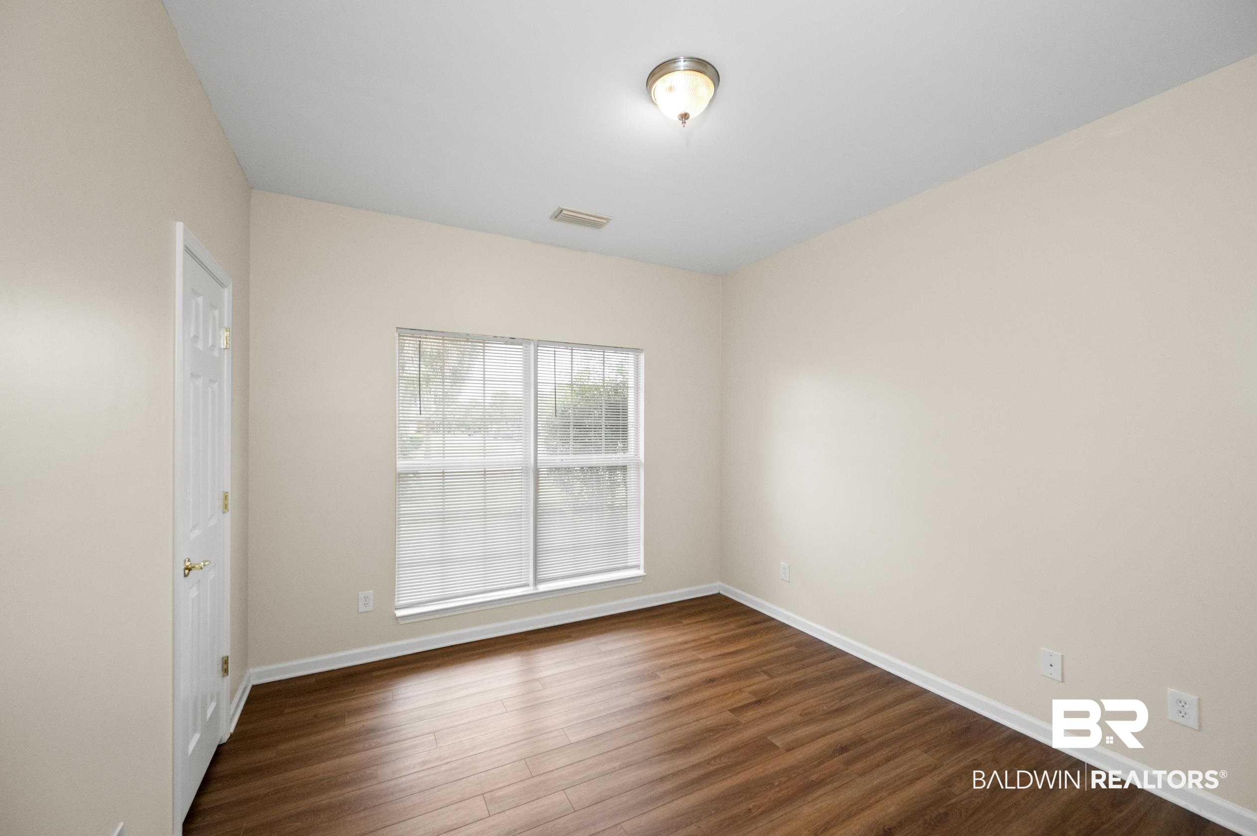 1333 Dominoe Trail Foley, AL 36535 - Photo 18 of 32 Empty room with dark wood-type flooring