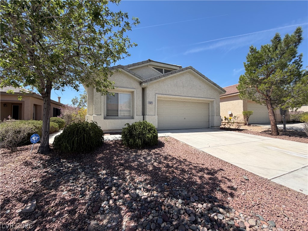 10975 Pumpkin Ridge Avenue Las Vegas, NV 89135 - Photo 13 of 13 A well-maintained facade with an attached garage and desert landscaping welcomes you home.