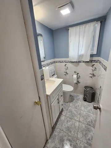 a bathroom with a sink a toilet and mirror