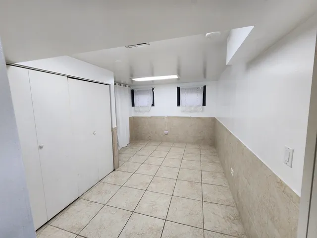 a view of a kitchen with a dishwasher and a refrigerator