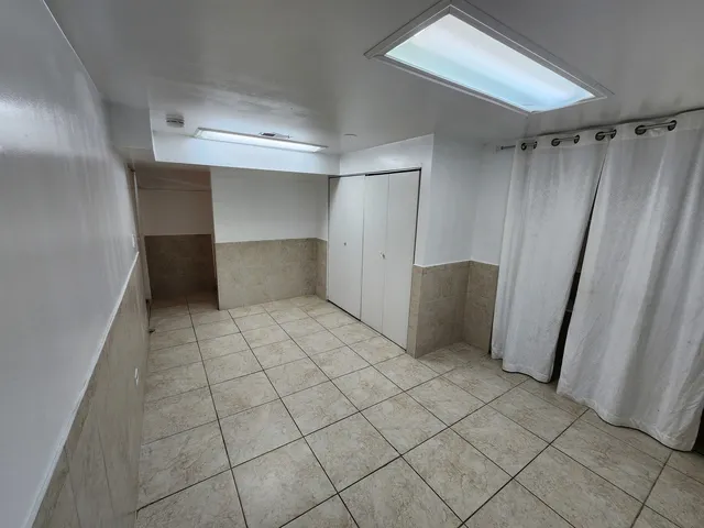 a view of a backyard with wooden fence