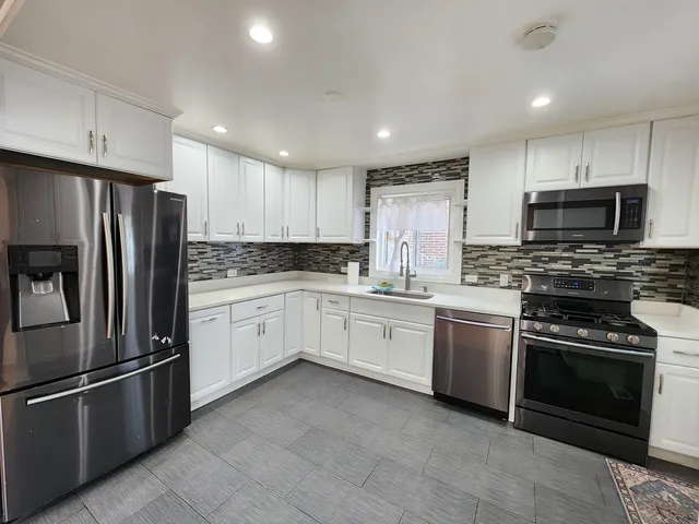 a kitchen with a refrigerator stove and microwave