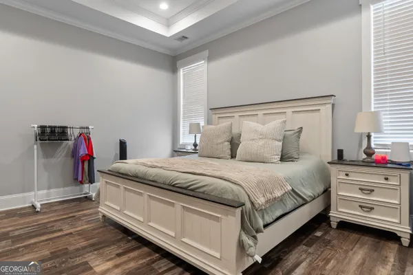 a spacious bedroom with a bed and a chandelier
