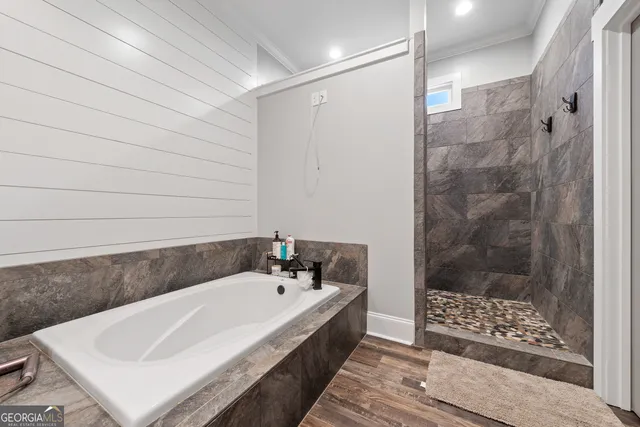 a view of a hallway with wooden floor and entryway