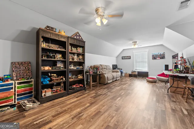 a spacious bedroom with a bed and a chandelier
