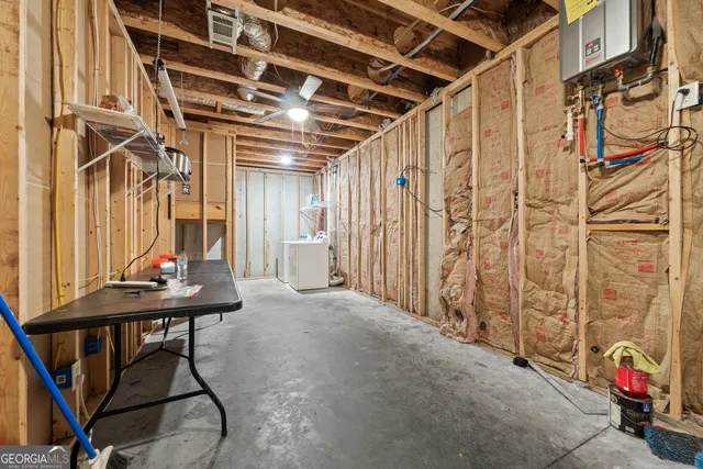 a bathroom with a granite countertop double vanity sink and mirror