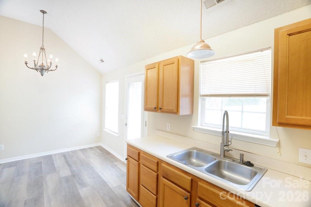 122 Addison Place Troutman, NC 28166 - Photo 11 of 40 a kitchen with a sink cabinets and window