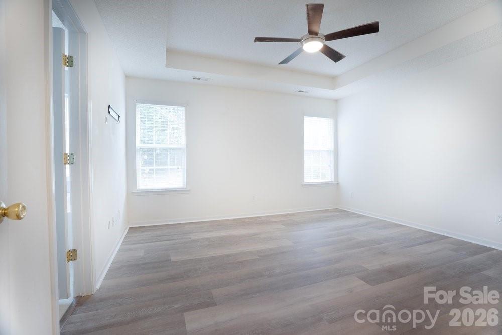 122 Addison Place Troutman, NC 28166 - Photo 16 of 40 an empty room with windows and fan