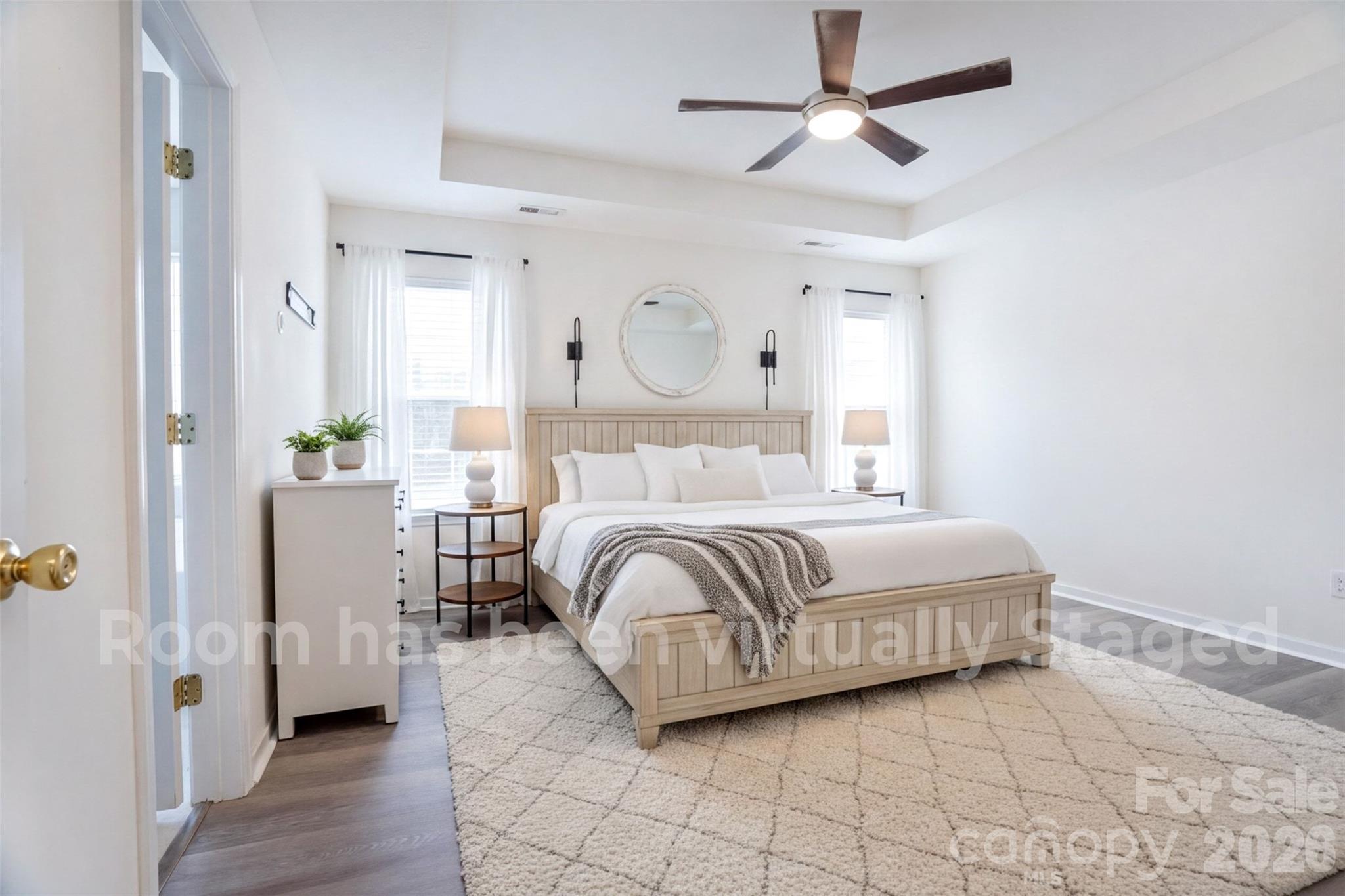 122 Addison Place Troutman, NC 28166 - Photo 17 of 40 a bedroom with a bed and a chandelier