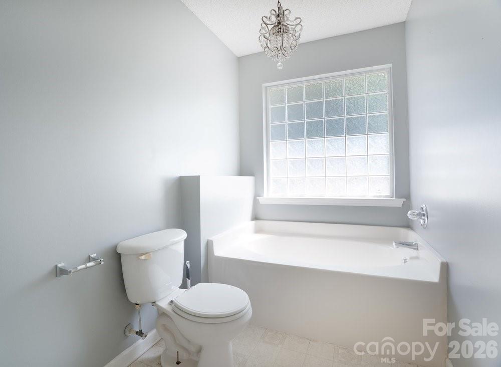 122 Addison Place Troutman, NC 28166 - Photo 20 of 40 a bathroom with a toilet a sink and bathtub