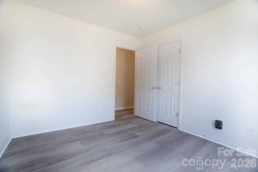 122 Addison Place Troutman, NC 28166 - Photo 26 of 40 an empty room with wooden floor