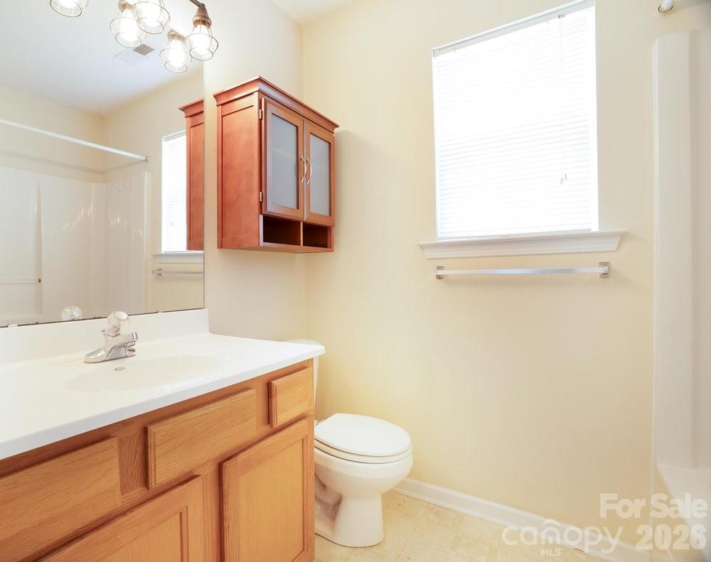 122 Addison Place Troutman, NC 28166 - Photo 28 of 40 a bathroom with a sink a toilet and mirror