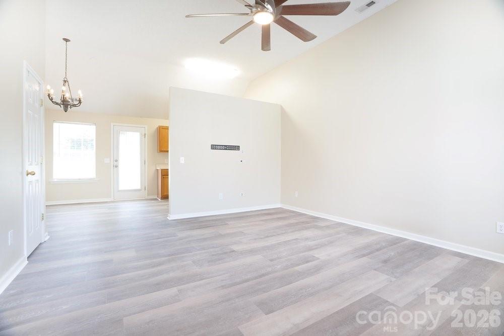 122 Addison Place Troutman, NC 28166 - Photo 4 of 40 a view of empty room with wooden floor and fan