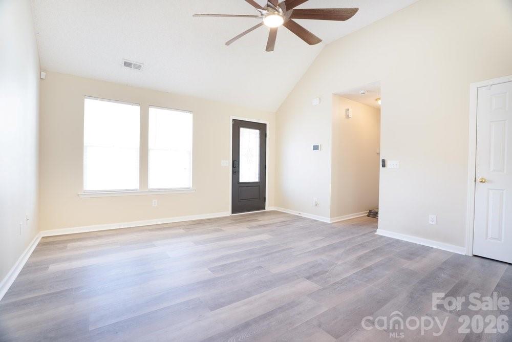 122 Addison Place Troutman, NC 28166 - Photo 7 of 40 a view of an empty room with a window